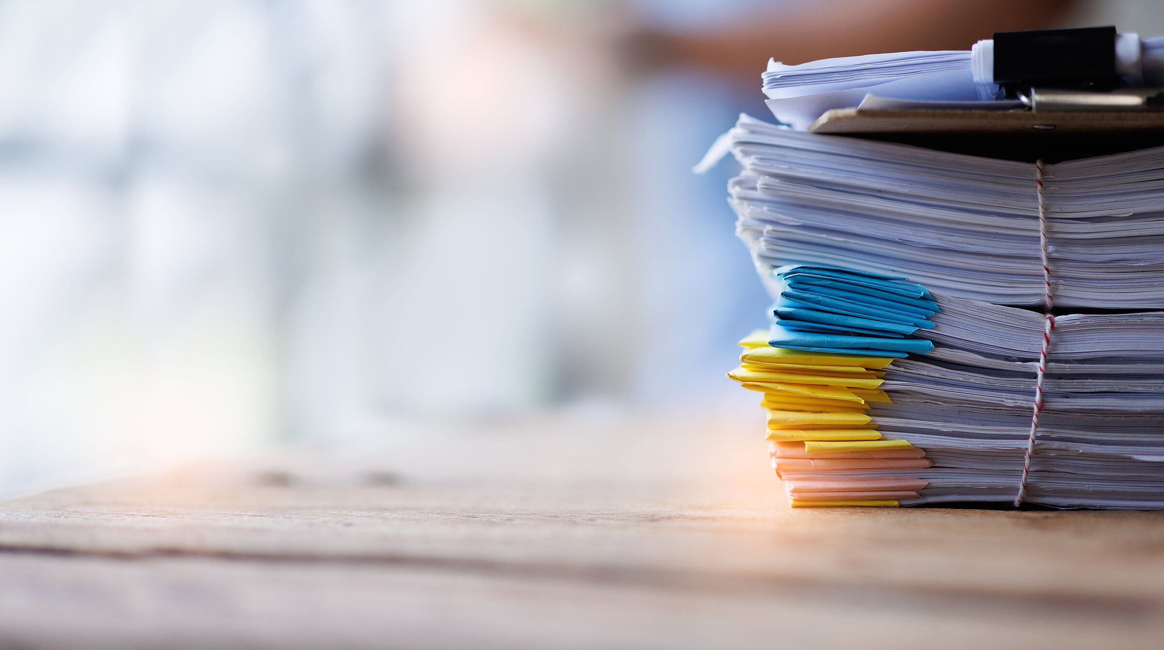 Document, a Stack of documents with a paper clip folder placed on a business desk in a business office.