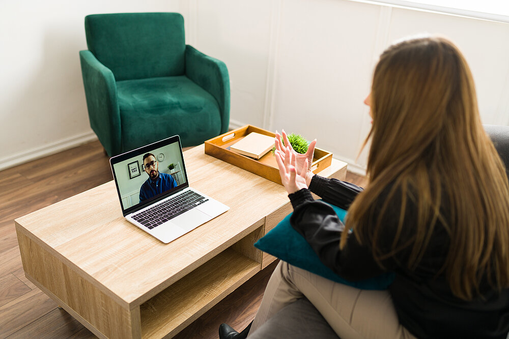 Stressed woman talking with a virtual therapist Stressed woman talking with a virtual therapist