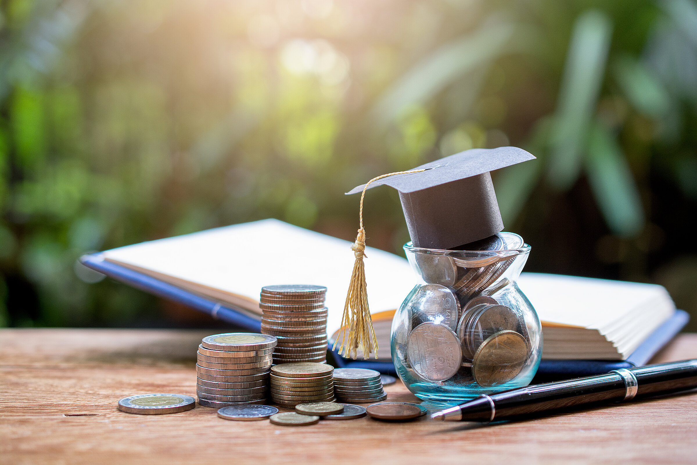 hat graduation model on book for concept investment education and scholarship