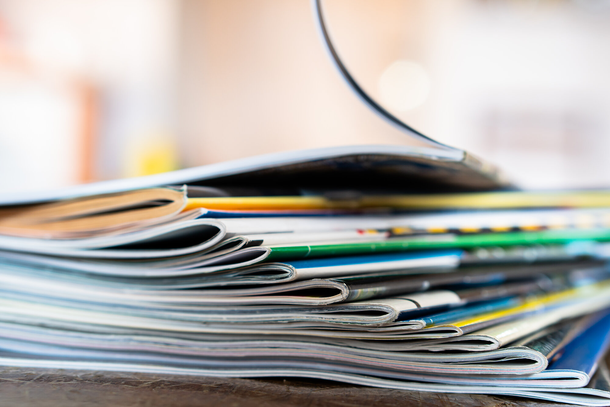 Closeup background of a pile of old magazines with bending pages